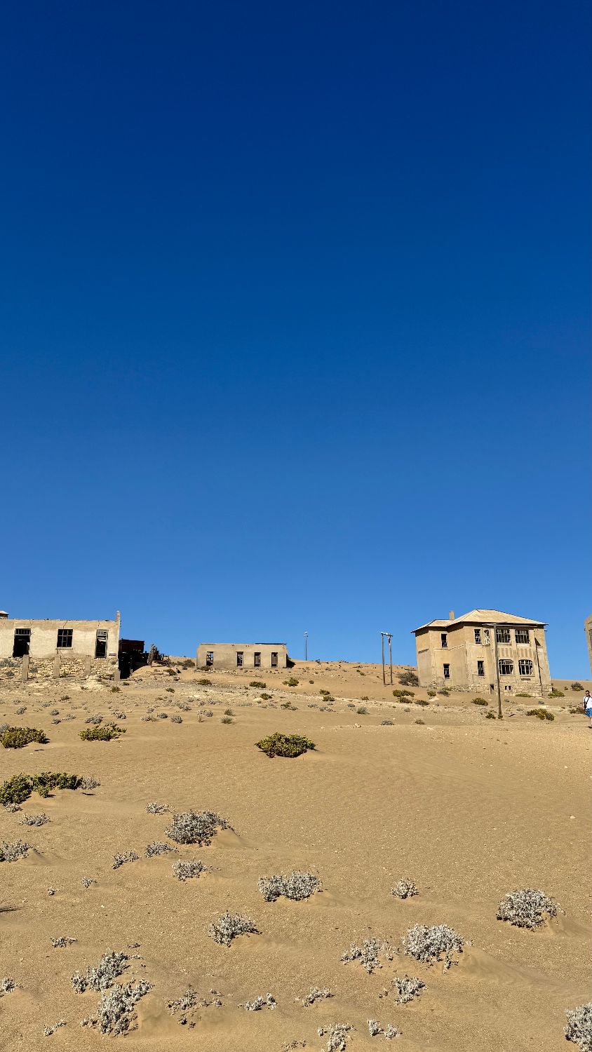 The houses on the ridge at Kolmanskop, seen across the sand