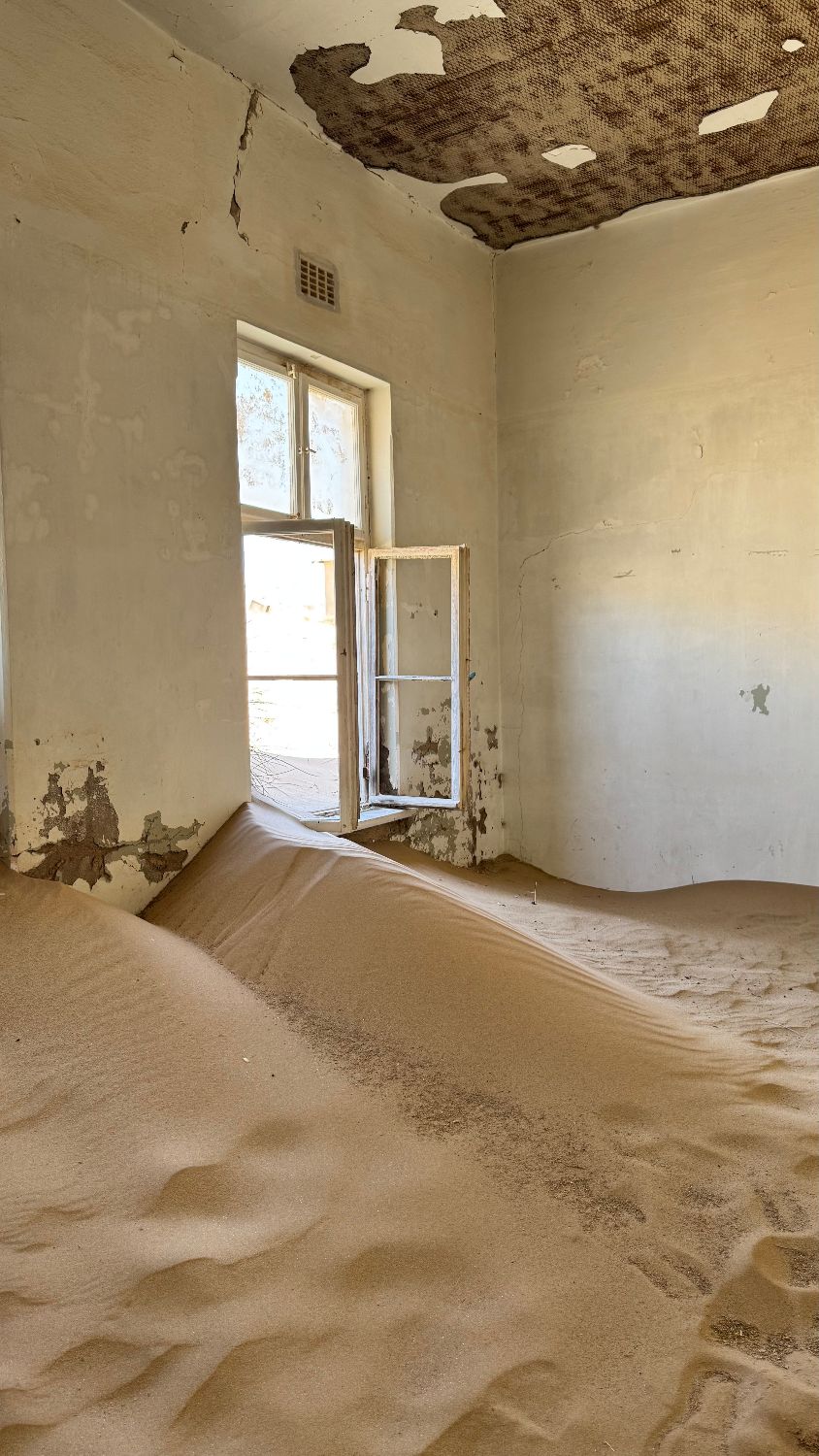 Sand drifted up to the windowsill of a Kolmanskop house